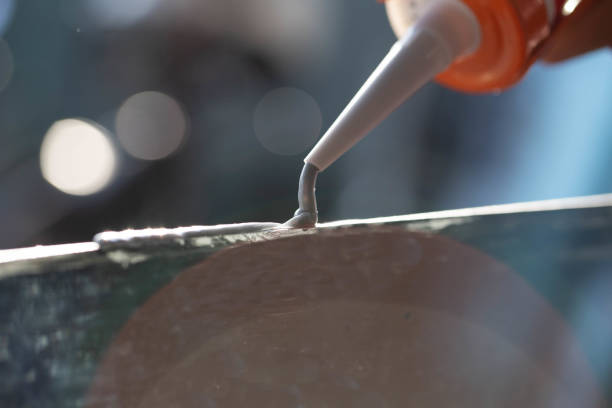 Craftsmen use silicone glue to fix glass work.